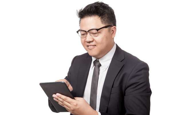Asian businessman use a tablet and smile - 写真・画像