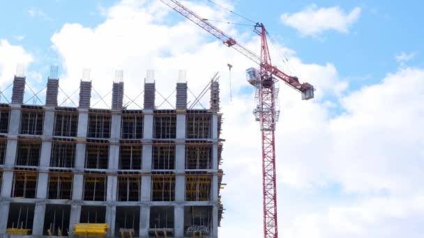 Residential building construction industry. Equity participation in the construction of a residential apartment building. Mortgage. Building under construction and a crane on the background of the sky - Footage, Video