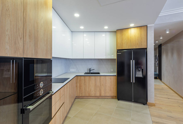 Modern belső tér világos fából készült konyha apartman. Fehér szekrények. - Fotó, kép
