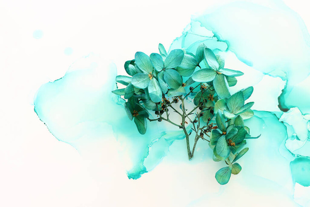 Creative image of emerald and green Hydrangea flowers on artistic ink background. Top view with copy space - Foto, Imagem