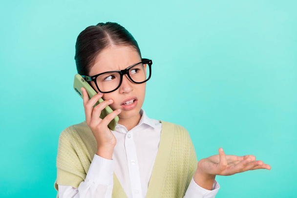 Photo of displeased lady hold telephone make important call wear green top isolated teal color background - Foto, imagen