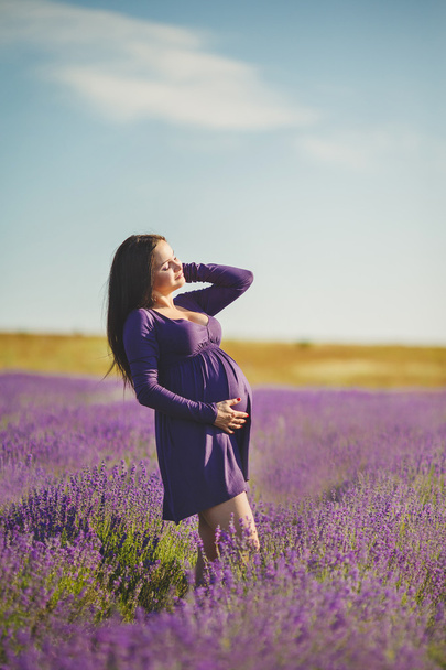 A pregnant woman is enjoying the color Lavender - Photo, Image