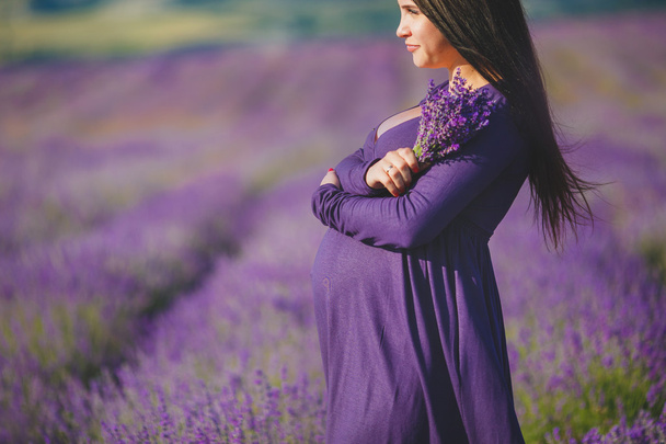 A pregnant woman is enjoying the color Lavender - Фото, зображення