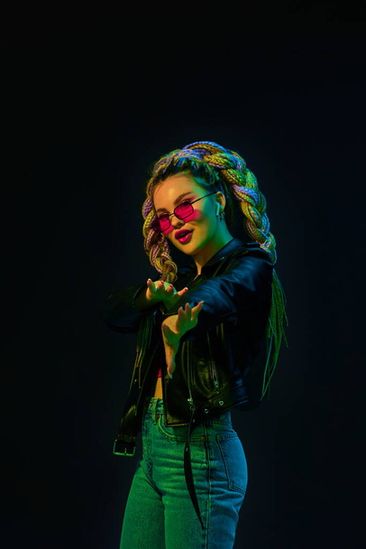 young woman with dreadlocks in red sunglasses dancing - Valokuva, kuva