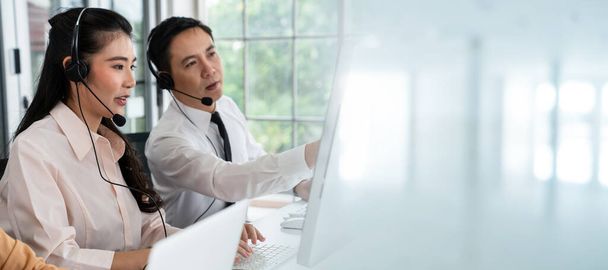 Business team wearing headset working actively in office - Photo, Image