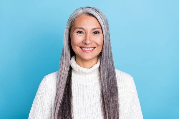 Photo of senior attractive cheerful woman toothy smile long hairstyle isolated over blue color background - Foto, immagini