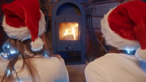 Ein verliebtes Paar starrt auf die Flammen des Feuers aus dem Ofen - Filmmaterial, Video