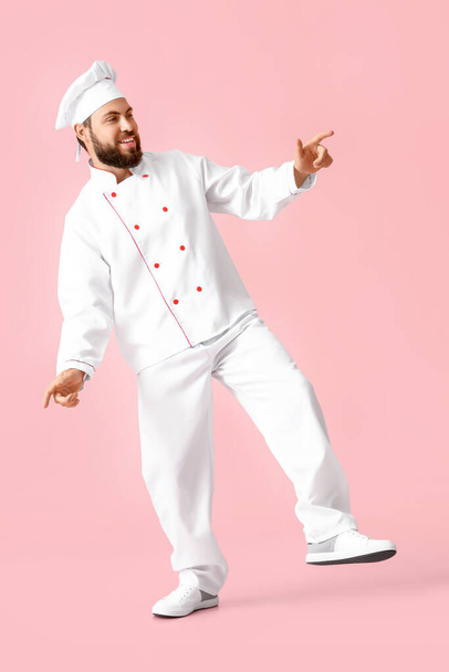 Dancing male chef on pink background - Photo, Image