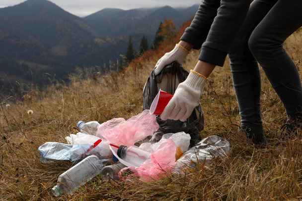 Woman with trash bag collecting garbage in nature, closeup - Fotoğraf, Görsel