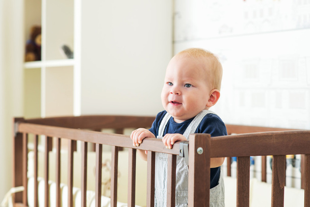 Baby boy in crib - Zdjęcie, obraz