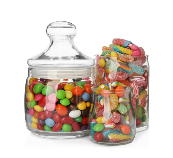 Glass jars with different candies on white background - Foto, Imagem