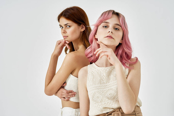 two girlfriends standing side by side posing fashion luxury - Foto, imagen