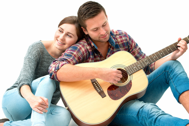 Young couple playing guitar - Фото, изображение