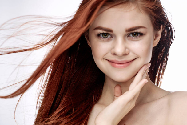 red-haired woman attractive look naked shoulders cosmetics smile - 写真・画像
