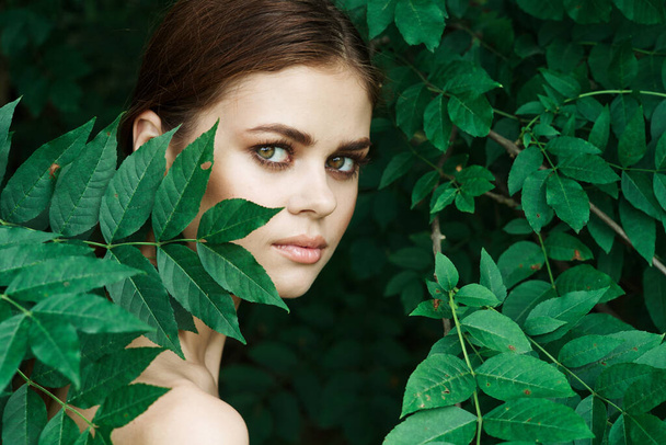 beautiful woman Cosmetology nature green leaves glamor close-up - Photo, Image