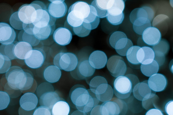 Christmas lights. Xmas. Festive New Year blurred blue and black background. Sparkling backdrop, texture. Bokeh. - Φωτογραφία, εικόνα