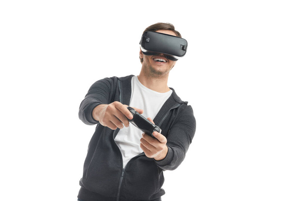 Cheerful man playing VR videogame - Foto, Bild