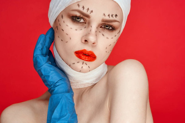 portrait of a woman posing in blue gloves red lips surgery facial rejuvenation studio lifestyle - Foto, imagen