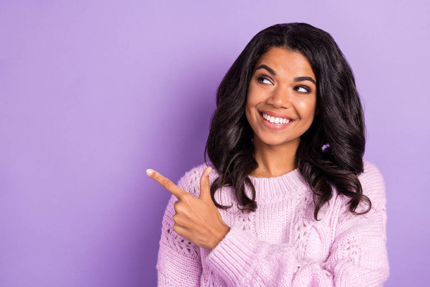Photo of young afro girl happy smile look point finger empty space ad advice choose direct way isolated over violet color background - Valokuva, kuva