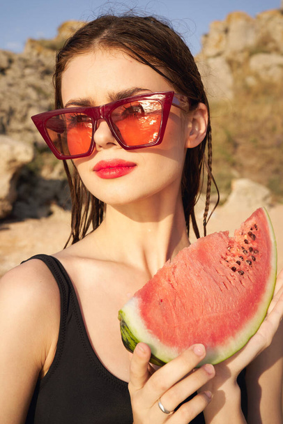 woman eating watermelon outdoors Sun summer close-up - 写真・画像