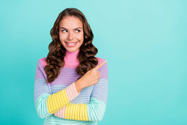 Photo of cute brunette young lady indicate look empty space wear violet sweater isolated on teal color background - Photo, Image