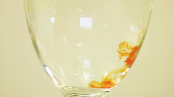 Color Dye Being Added Into Wine Glass - Orange - Materiał filmowy, wideo