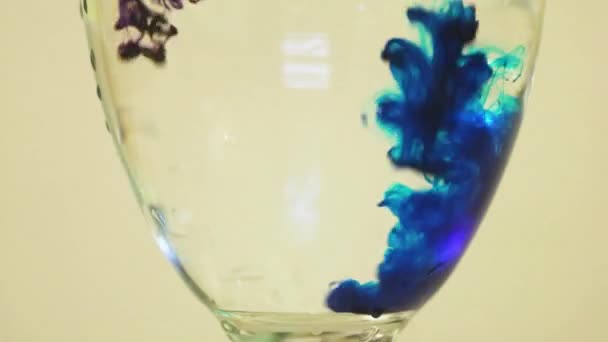 Color Dyes Being Added Into Wine Glass - Blue And Purple - Metraje, vídeo