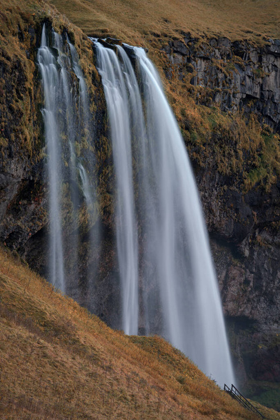 Seljalandfoss Waterfall in Iceland long exposure with hiking path - Fotó, kép