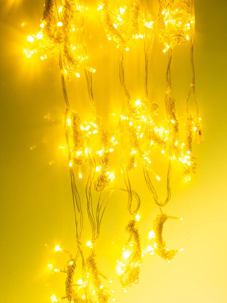 multicolored garland with small led bulbs on a dark background - Foto, Bild