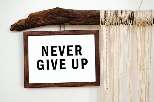 The words Never give up written on a white paper. Motivation concept - Photo, Image