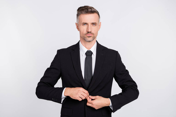 Photo of serious attractive mature specialist dressed black suit button up jacket isolated grey color background - Foto, Imagem