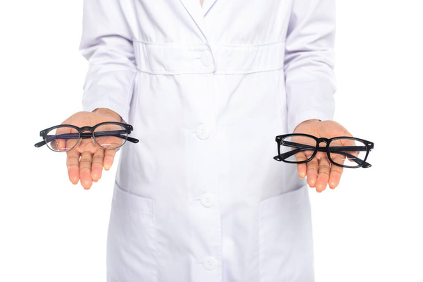 Cropped view of african american oculist holding eyeglasses isolated on white  - Φωτογραφία, εικόνα