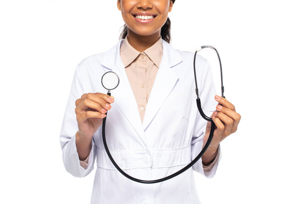 Cropped view of african american doctor smiling while holding stethoscope isolated on white - Φωτογραφία, εικόνα