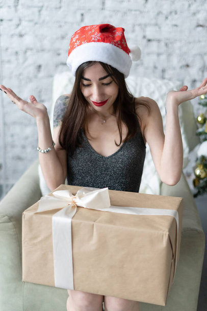 young woman unpacking a gift for the new year - Фото, изображение