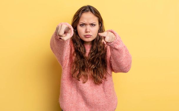 hispanic pretty woman pointing forward at camera with both fingers and angry expression, telling you to do your duty - Photo, image