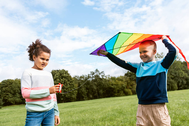 happy boy and girl with kite playing at park - Foto, Imagen