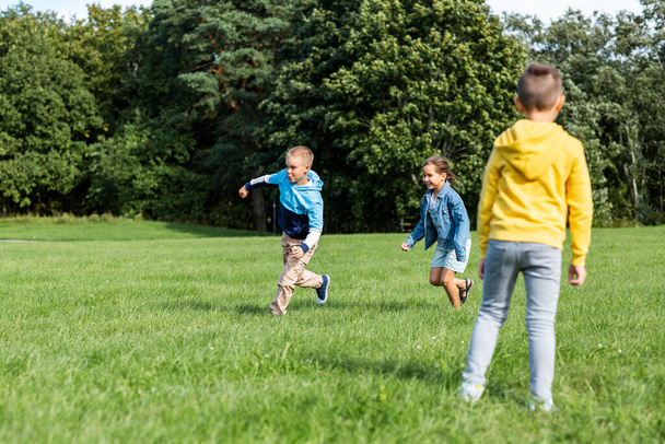 happy children playing and running at park - Fotoğraf, Görsel