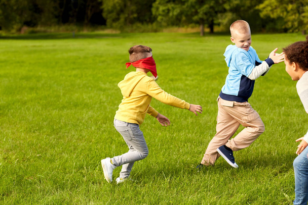 happy children playing and running at park - Φωτογραφία, εικόνα