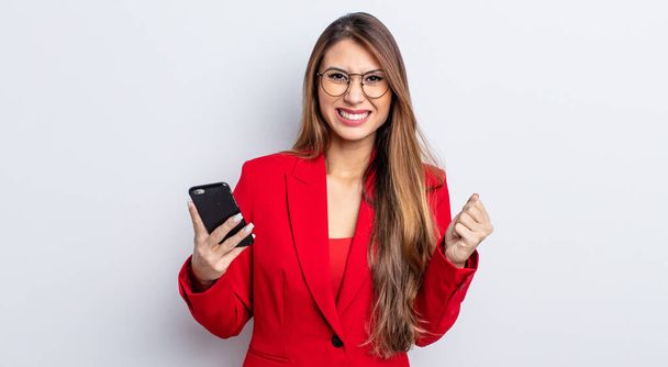 asiatic pretty woman shouting aggressively with an angry expression. business and phone concept. - Photo, Image