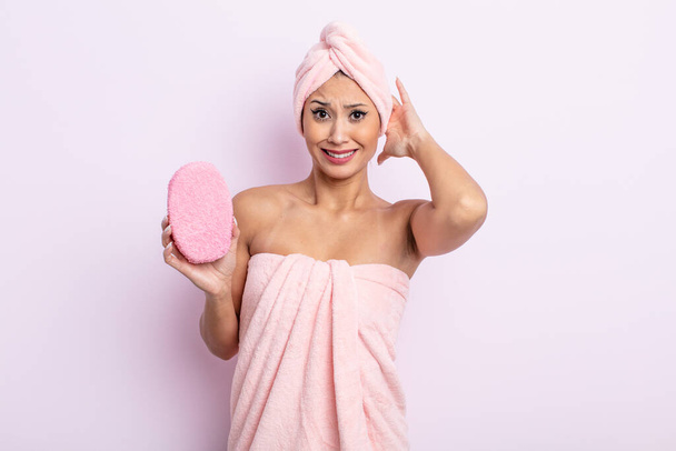 asiatic pretty woman feeling stressed, anxious or scared, with hands on head. bathrobe and sponge concept - Photo, image