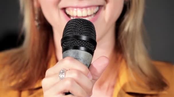 Singing at microphone in music studio - Video, Çekim