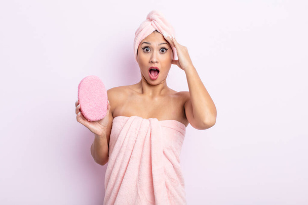 asiatic pretty woman looking happy, astonished and surprised. bathrobe and sponge concept - Photo, image