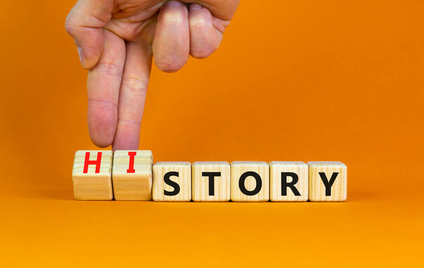 Story and history symbol. Historic turns a cube, changes the word story to history. Beautiful orange table, orange background. Business, historical and story or history concept. Copy space. - Photo, image