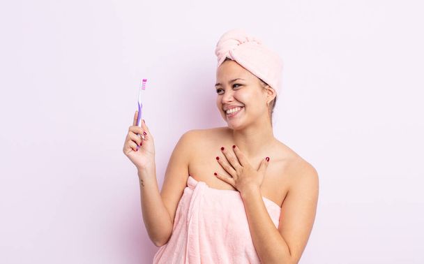 hispanic pretty woman smiling with a happy, confident expression with hand on chin tooth brush concept - Фото, изображение