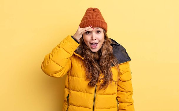 hispanic pretty woman looking happy, astonished and surprised. winter clothes - Foto, imagen