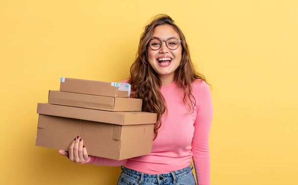 hispanic pretty woman looking happy and pleasantly surprised. storage concept - Photo, image