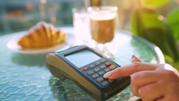 Contactless payment with smartphone. Wireless payment concept. Close-up, woman using smartphone cashless wallet NFC technology to pay order on bank terminal in a cafe. - Footage, Video