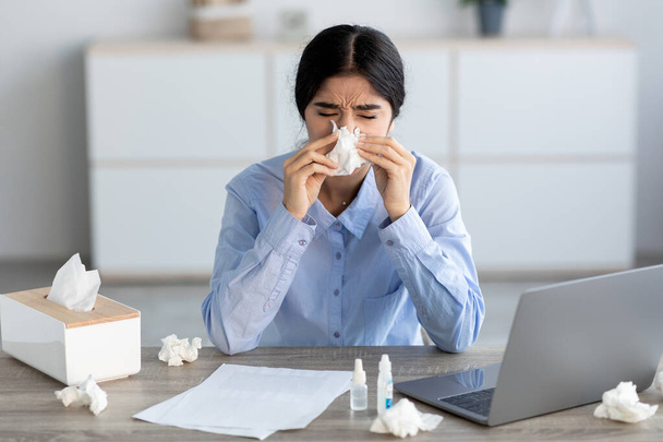 Unhappy young hindu female manager, blows nose in napkin, suffers from headache and cold - Photo, Image