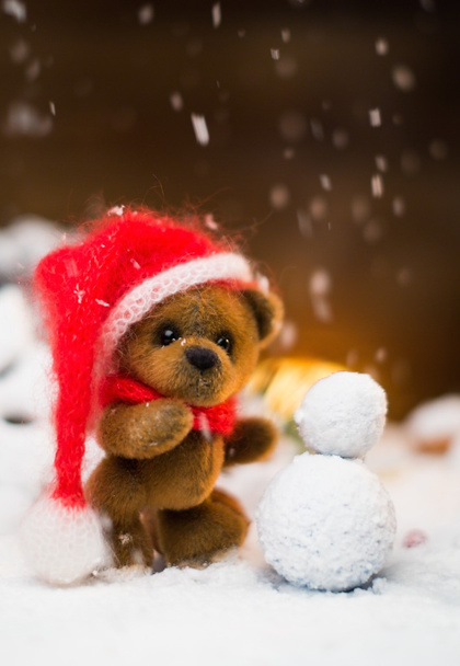 Small toy bear making snowman in christmas still life  - Photo, Image