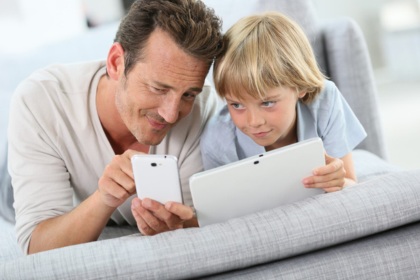 Father and son with tablet and smartphone - Fotoğraf, Görsel